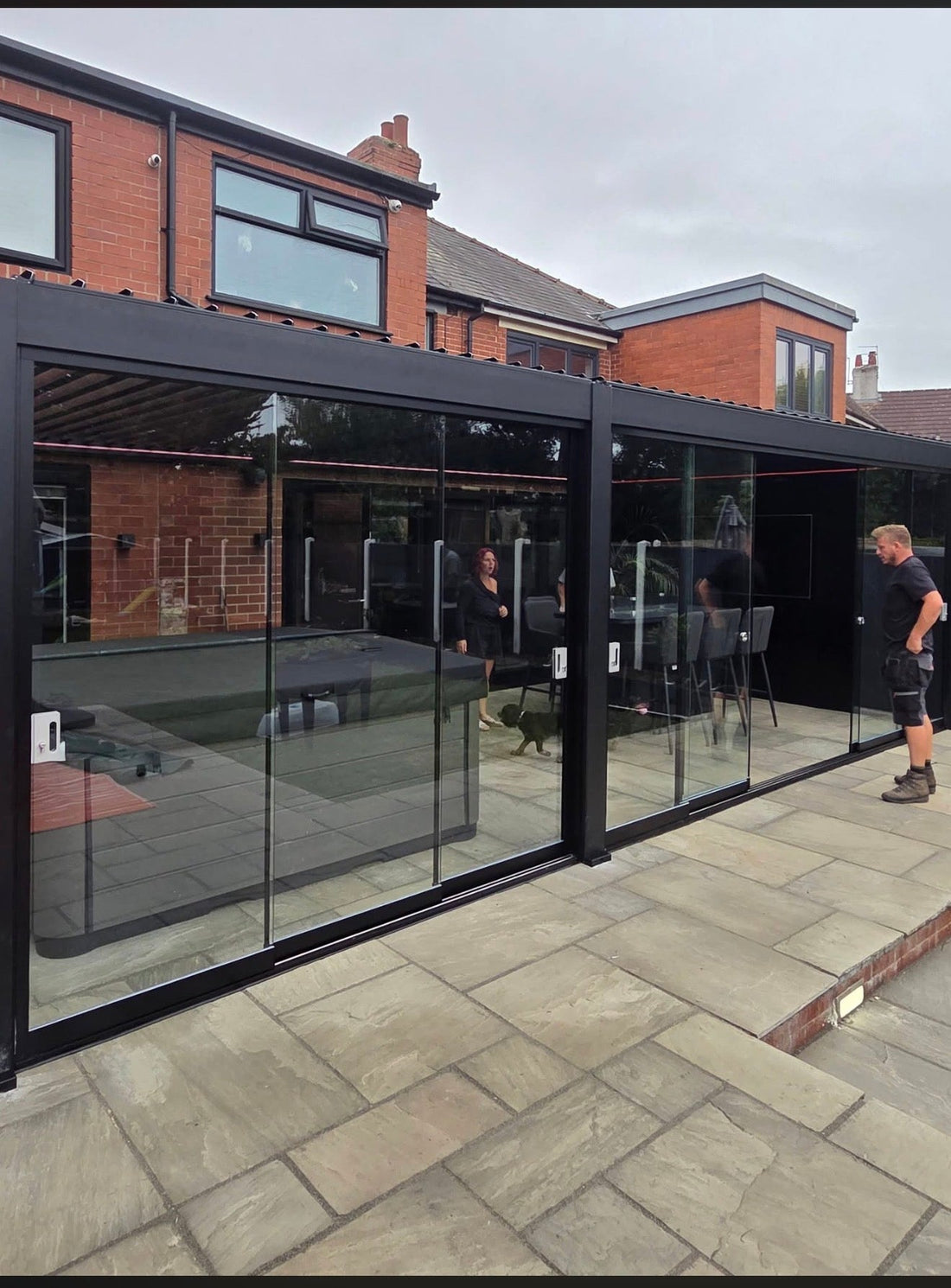 Pergo Vista aluminium pergola with motorised louvred roof and full-height glass sliding doors installed in Blackpool — statement build by Bespoke Oak and Slate