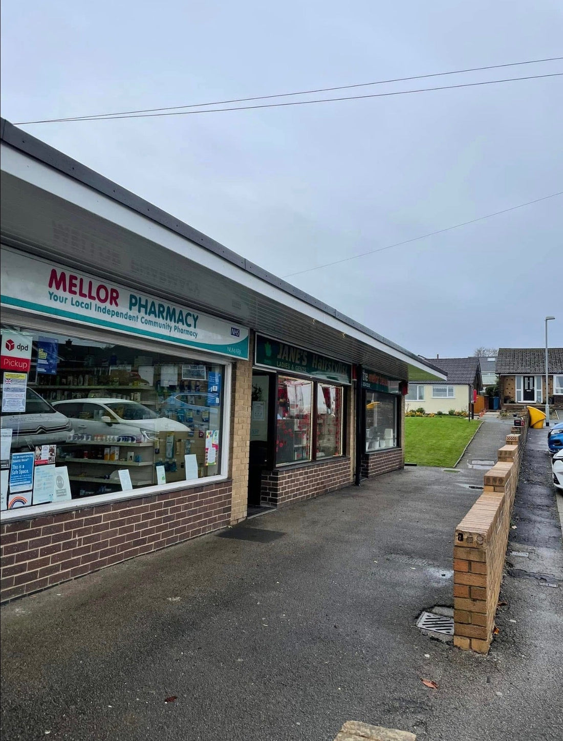 Completed white uPVC soffit and fascia fitted to shop canopy in Mellor Lancashire, viewed from below showing clean new finish after rotten timber replacement