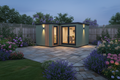 Sage green vertical cladding with warm wall lights